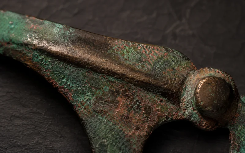 Patinated ancient bronze with verdigris layers — illustrative