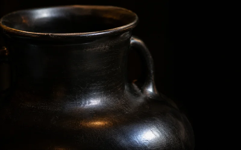 Burnished dark bucchero ceramic surface — illustrative